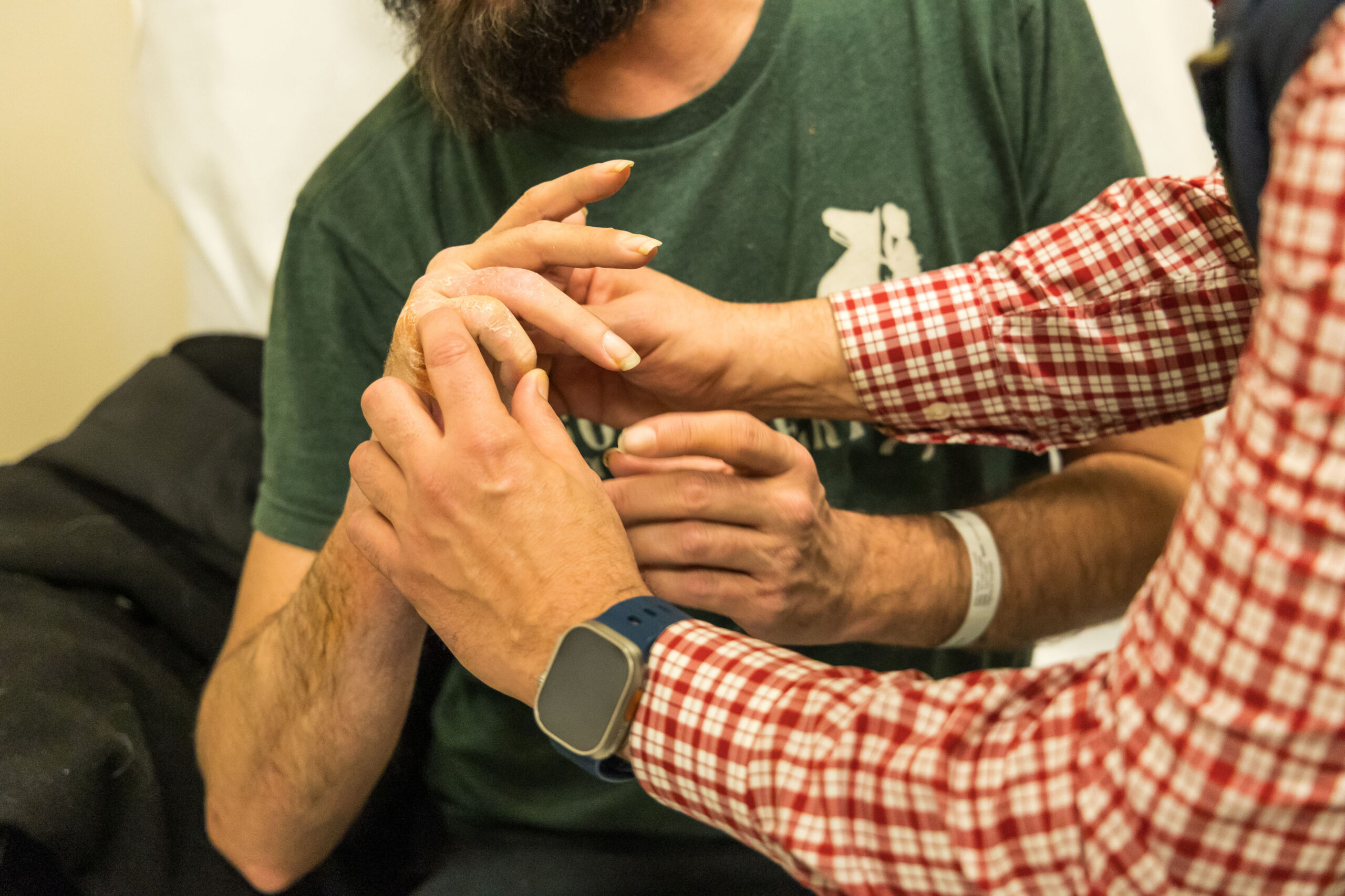 Ortho Surgeon examining patients hand.