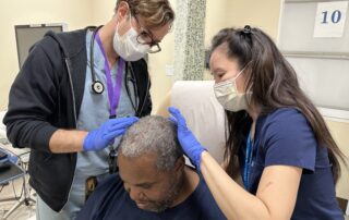 AHS doctors check a patient's skin